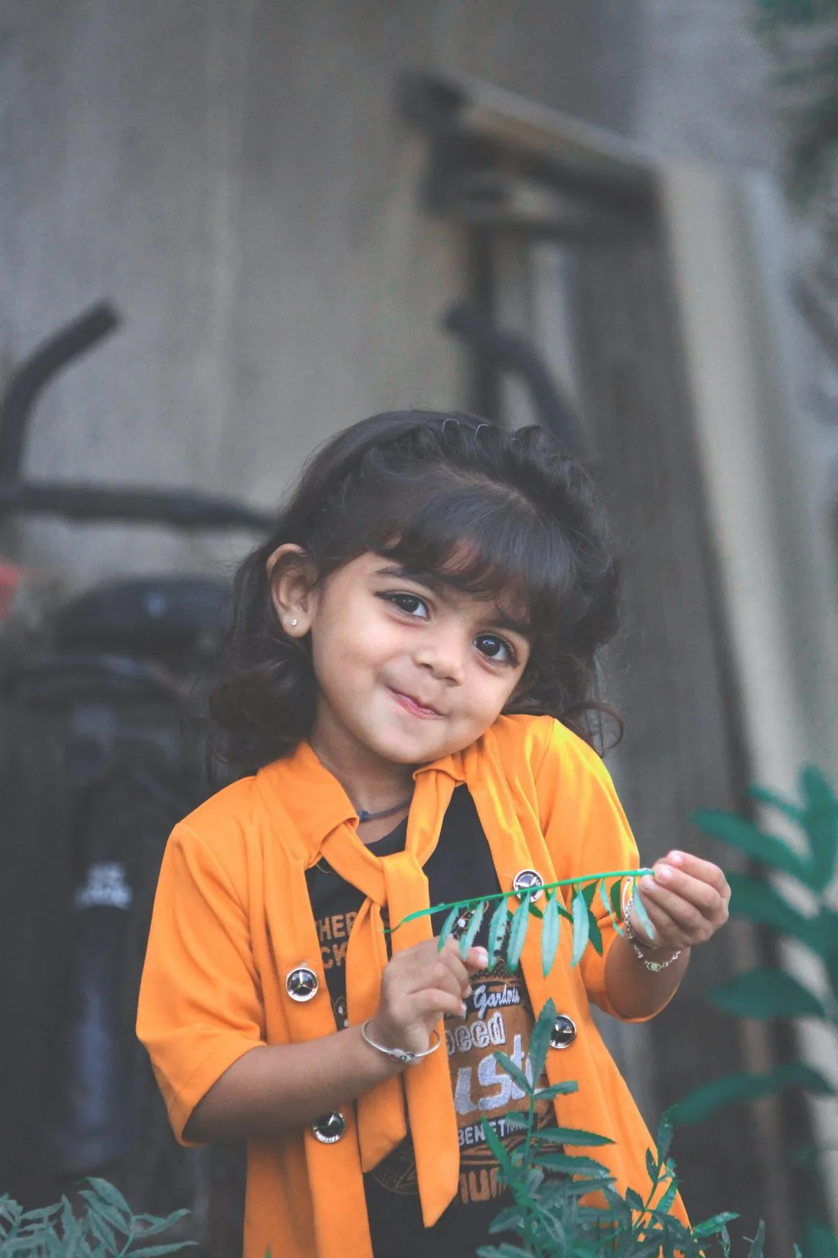 Smiling girl holding green leaves