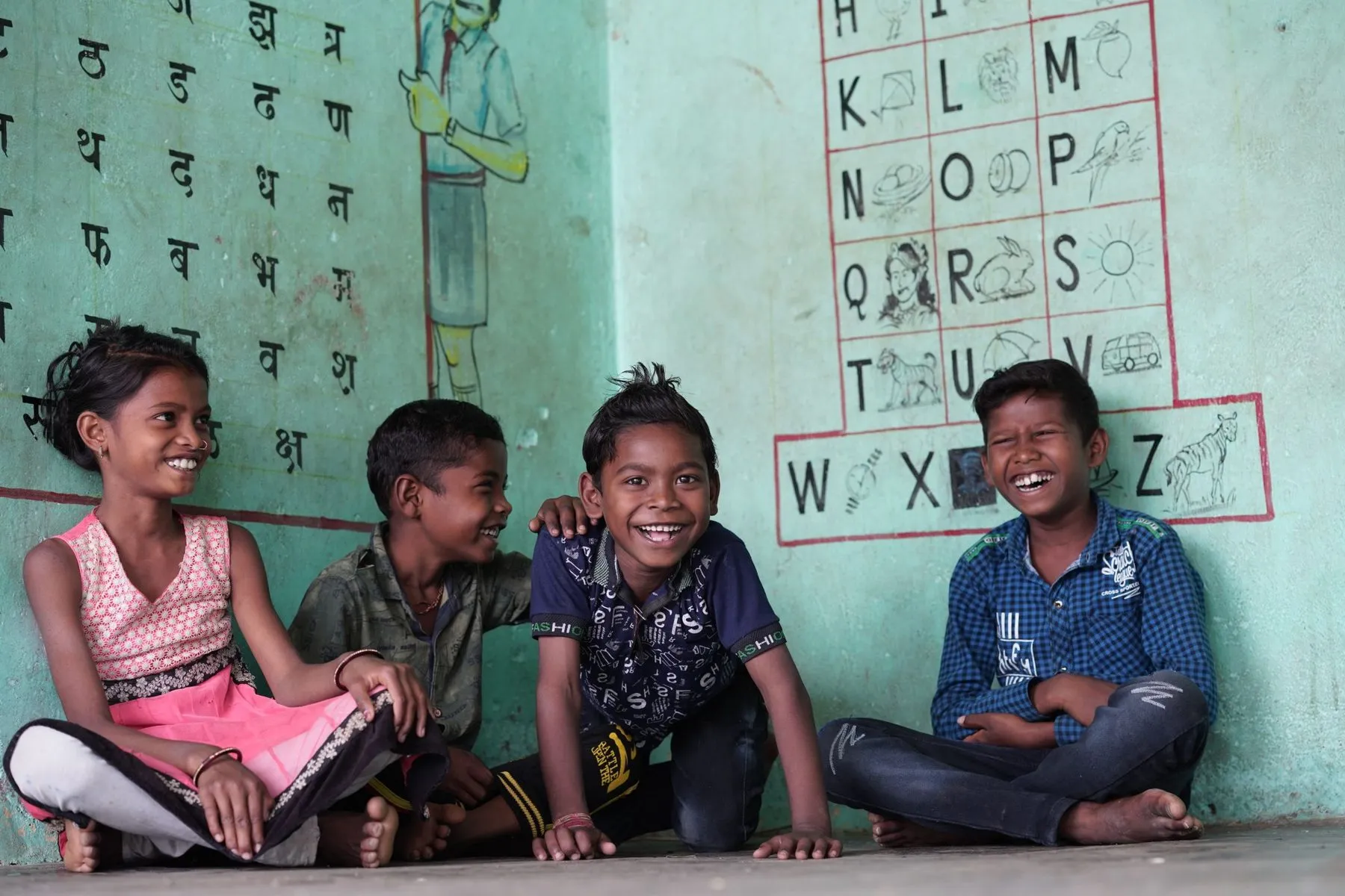 Children laughing together in a classroom